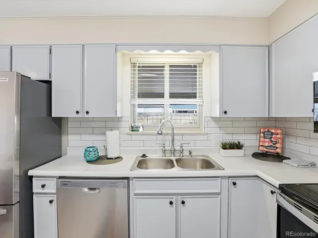 a kitchen with a sink cabinets and window