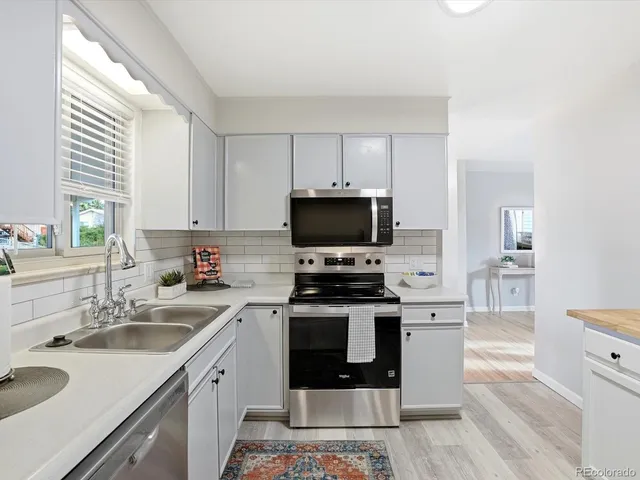 a kitchen with cabinets a sink and a stove