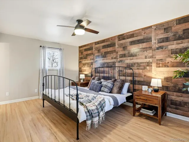 a bedroom with furniture and wooden floor