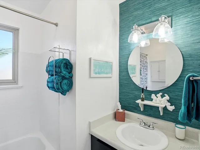 a bathroom with a sink a mirror and a toilet