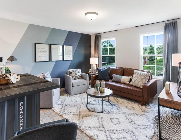 a living room with furniture a rug and a window
