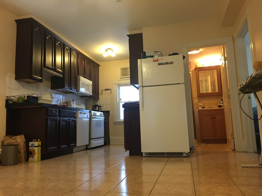 a kitchen with refrigerator and microwave