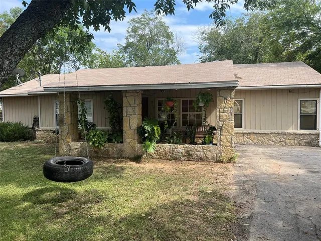a view of a house with backyard outdoor seating and hardwood