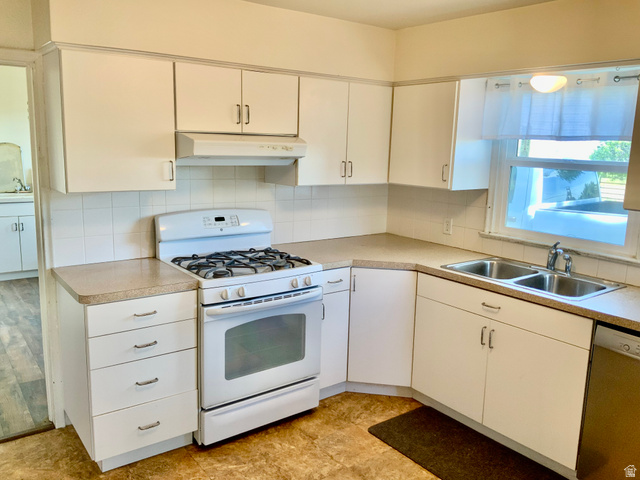 630 North Main Street Monroe, UT 84754 - Photo 4 of 63 Kitchen with white gas range oven, dishwasher, white cabinets, and tasteful backsplash