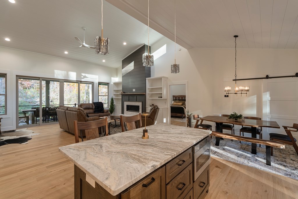 1214 John Abernathy Road Blairsville, GA 30512 - Photo 11 of 53 a kitchen with stainless steel appliances granite countertop a sink counter space and living room view