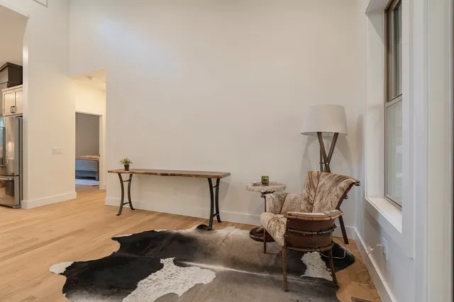 a bedroom with a bed a couch and a large window