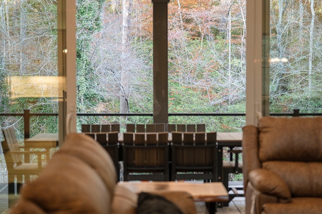 1214 John Abernathy Road Blairsville, GA 30512 - Photo 13 of 53 a living room with furniture and a floor to ceiling window