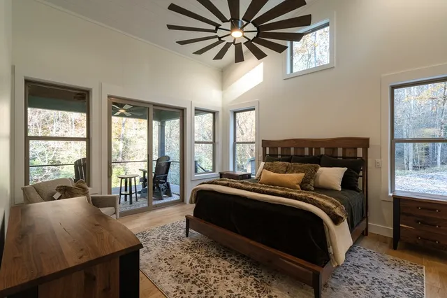 a living room with furniture and a floor to ceiling window