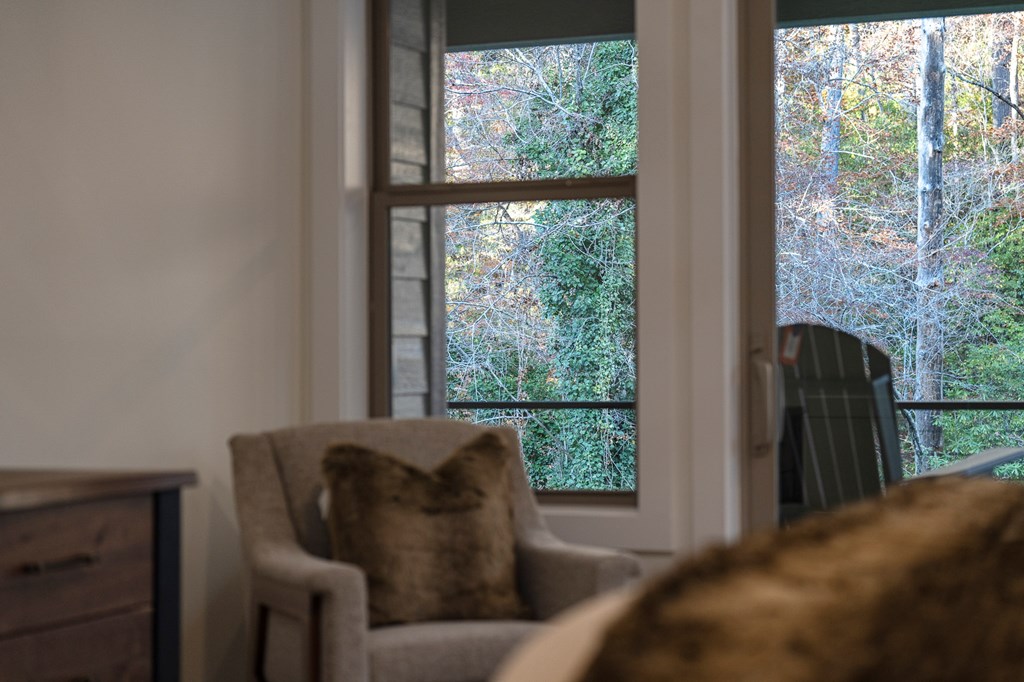 1214 John Abernathy Road Blairsville, GA 30512 - Photo 16 of 53 a living room with furniture and a floor to ceiling window