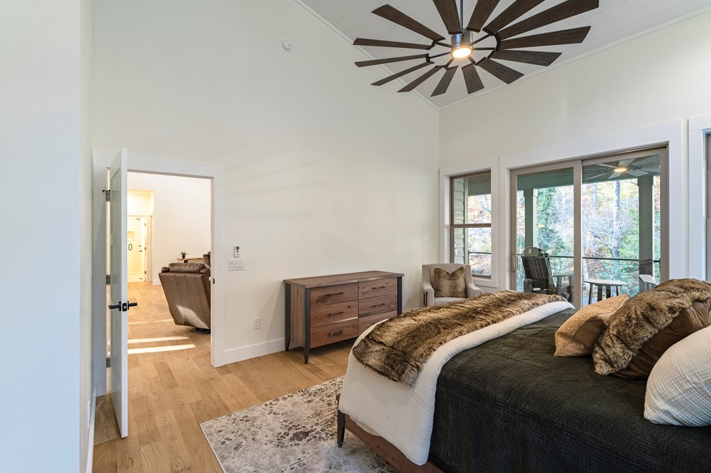 1214 John Abernathy Road Blairsville, GA 30512 - Photo 17 of 53 a bedroom with a bed and a chandelier