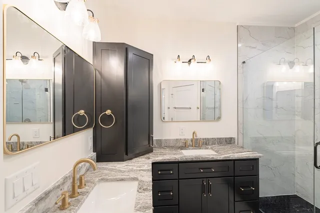 a bathroom with a sink a toilet and shower