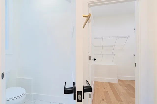 a bed room with a bed and a chair