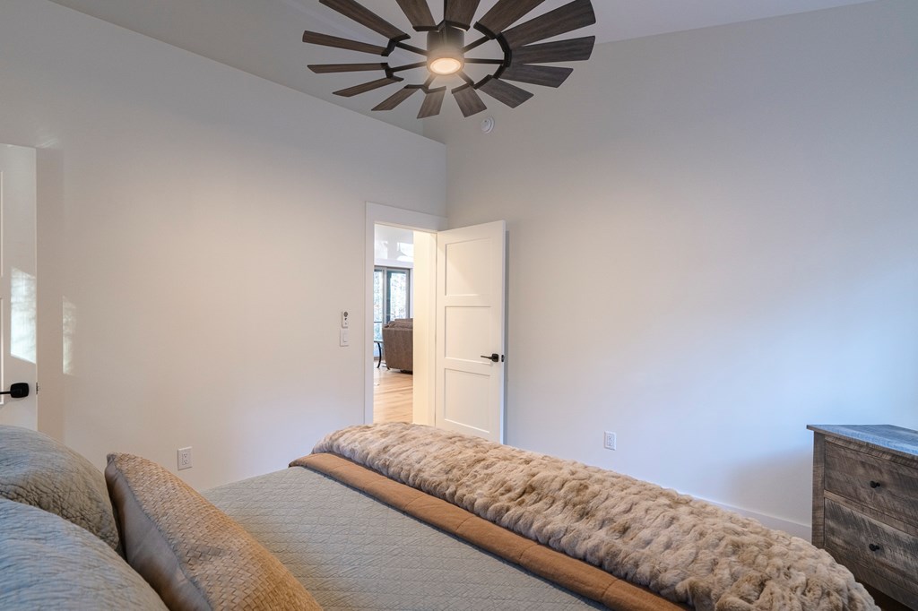 1214 John Abernathy Road Blairsville, GA 30512 - Photo 26 of 53 a bedroom with a bed and a chandelier