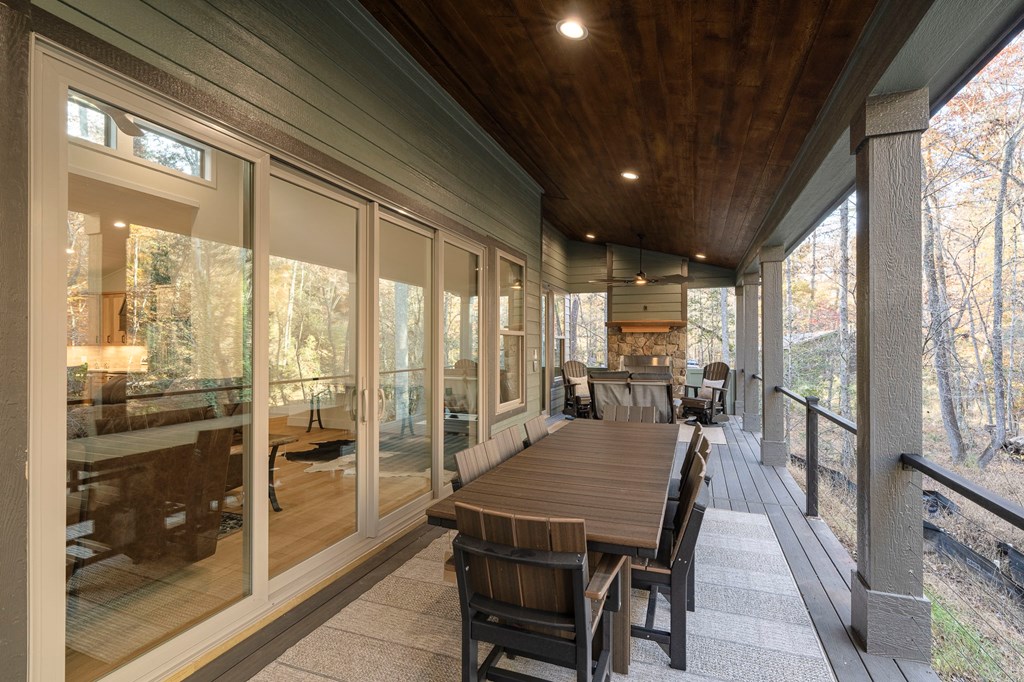 1214 John Abernathy Road Blairsville, GA 30512 - Photo 35 of 53 a view of a dining room with furniture large windows and wooden floor