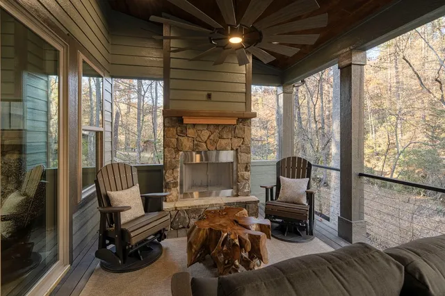 a living room with furniture and a floor to ceiling window