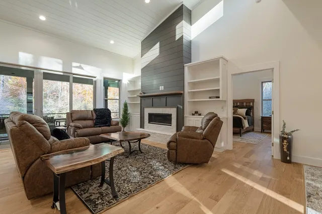 a dining room filled a chandelier a glass table and chairs