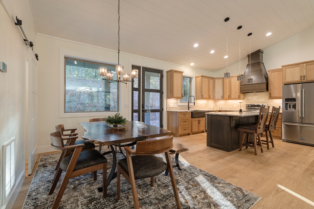 1214 John Abernathy Road Blairsville, GA 30512 - Photo 6 of 53 a dining room filled a chandelier a glass table and chairs
