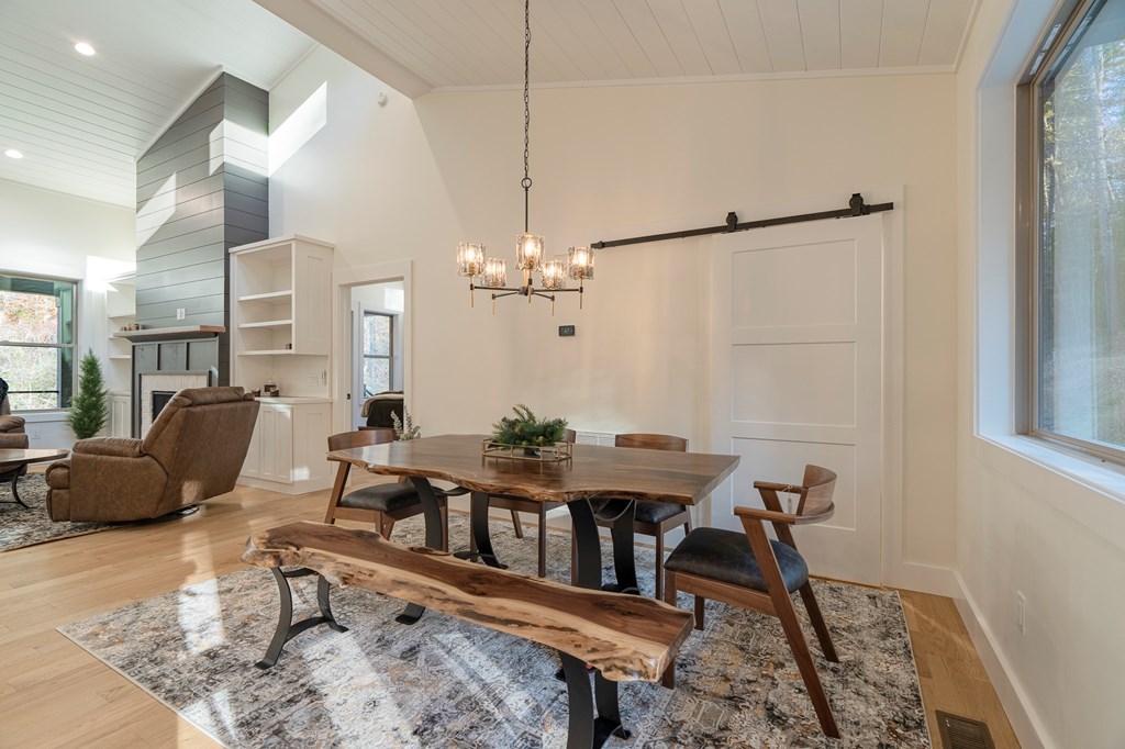 1214 John Abernathy Road Blairsville, GA 30512 - Photo 8 of 53 a living room with furniture a dining table and a chandelier