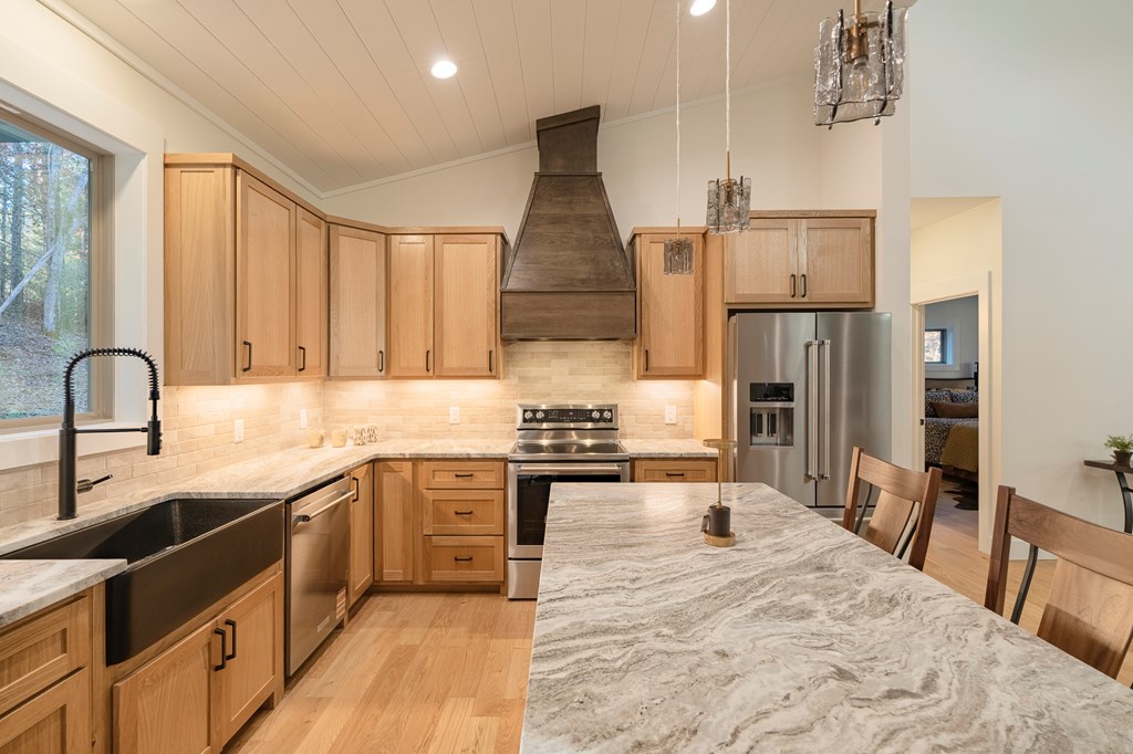 1214 John Abernathy Road Blairsville, GA 30512 - Photo 10 of 53 a kitchen with stainless steel appliances granite countertop a sink stove and refrigerator