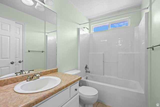 142 East 2675th Street South Clearfield, UT 84015 - Photo 27 of 49 Full bathroom featuring a white tub with integrated shower, a vanity with an oval sink, a light-colored countertop, and a mirror