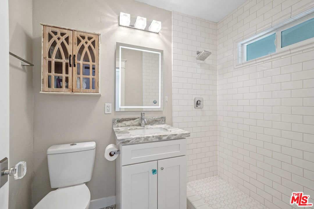 54 West Glenarm Street Pasadena, CA 91105 - Photo 11 of 18 a bathroom with a toilet a sink and mirror