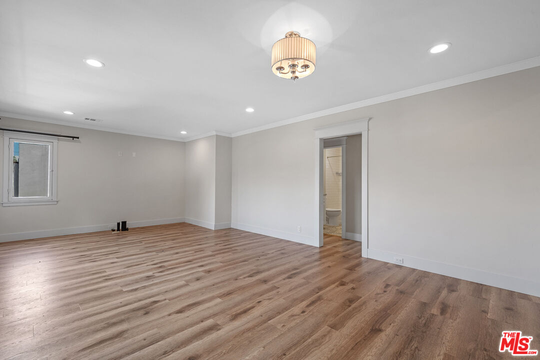 54 West Glenarm Street Pasadena, CA 91105 - Photo 4 of 18 a view of an empty room with wooden floor and a window