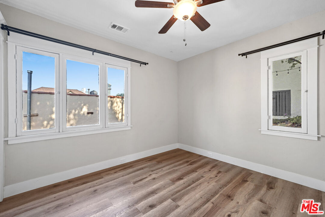 54 West Glenarm Street Pasadena, CA 91105 - Photo 5 of 18 a view of an empty room with wooden floor and a window
