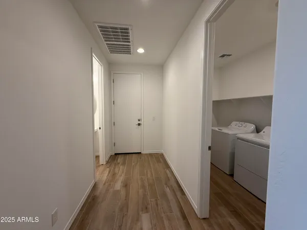 a view of hallway with wooden floor