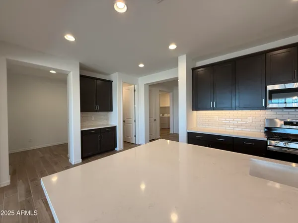a view of kitchen with sink and cabinets