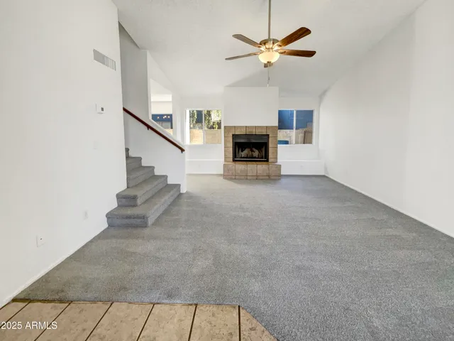 a view of an empty room with fireplace