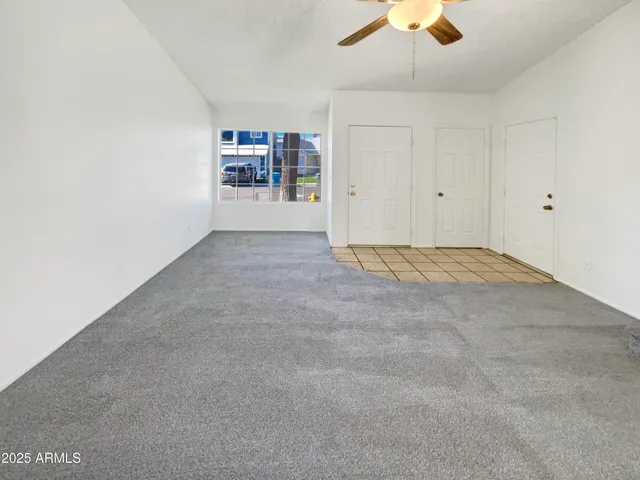 a view of empty room with a ceiling fan