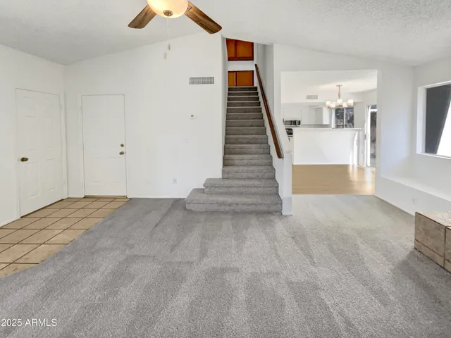 a view of a hallway with wooden floor and stairs