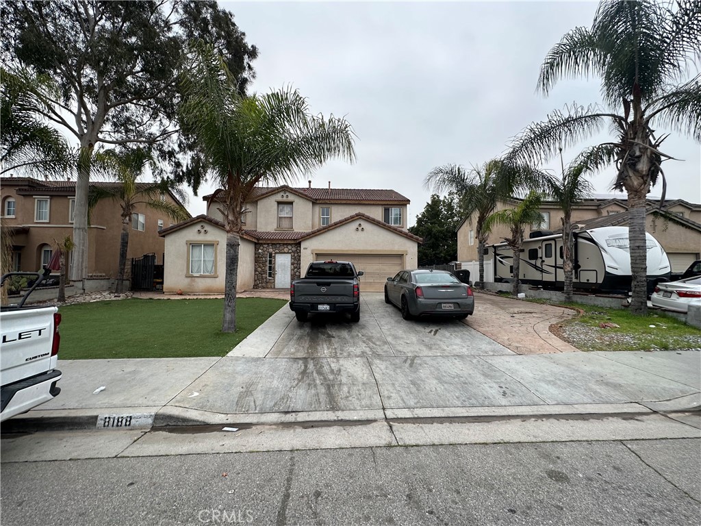 a car parked in front of a white house