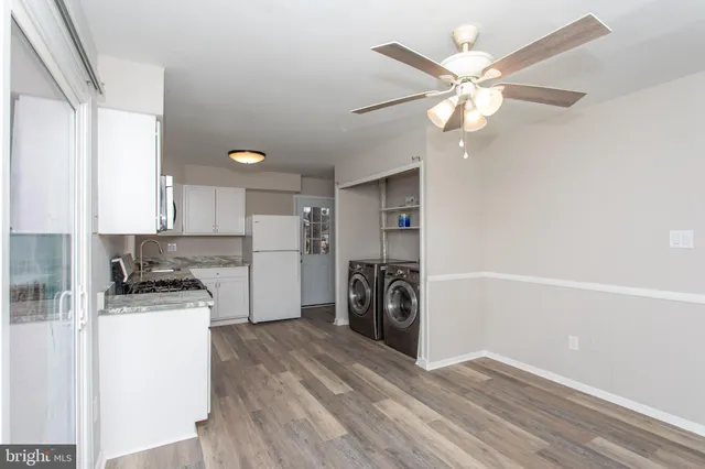 a view of a kitchen with a stove cabinets and a ceiling fan