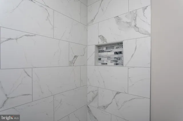 an empty room with closet and a ceiling fan