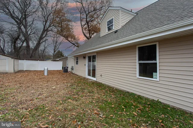 a view of backyard with wooden fence