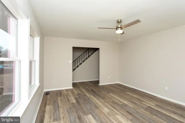 wooden floor in an empty room with a window