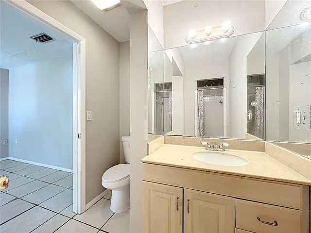 a backyard of house with garden and tall trees