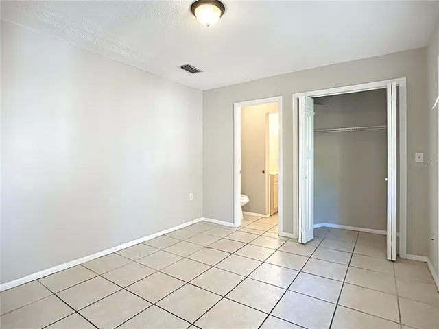 a view of a house with backyard and tree
