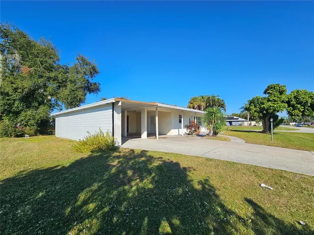 an aerial view of a house with swimming pool and lake view