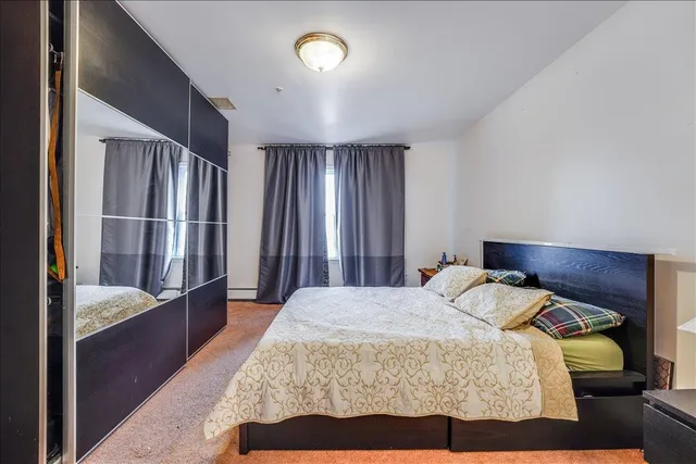 a bedroom with bed and window