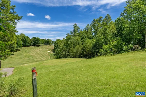 a view of a field with an trees in the background