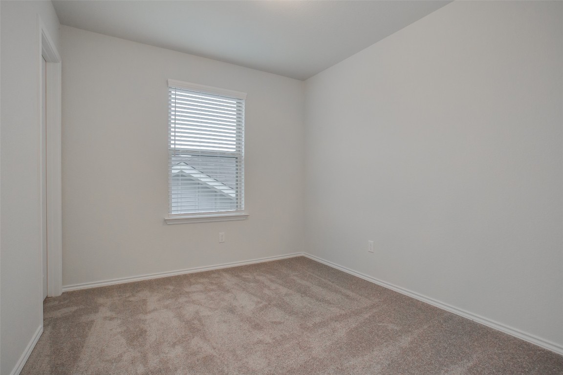 148 Spotted Rail Ridge Leander, TX 78641 - Photo 26 of 31 An inviting secondary bedroom providing a quiet retreat for rest and rejuvenation.