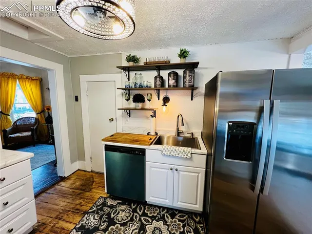 a kitchen with stainless steel appliances a stove a refrigerator and cabinets
