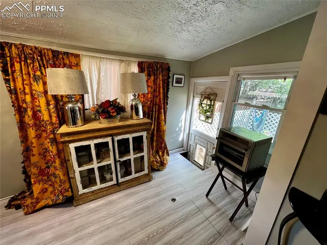 a view of a livingroom with furniture and a window