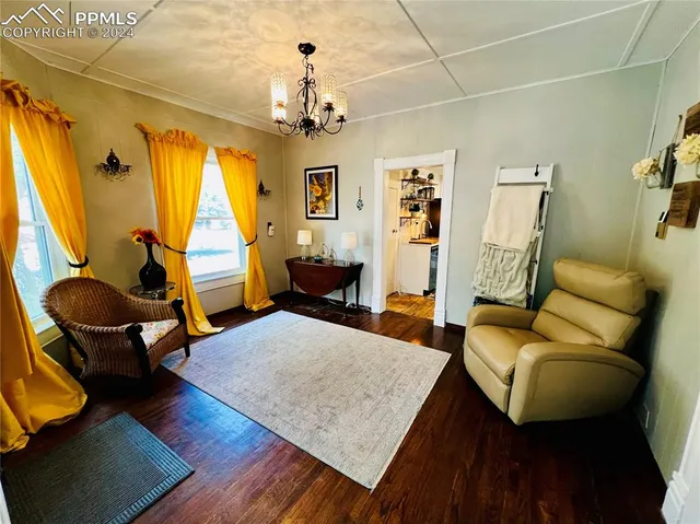 a living room with furniture and a chandelier