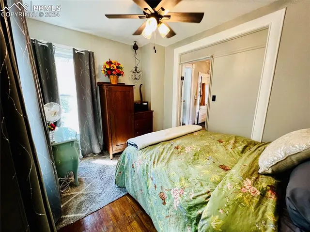 a bed sitting in a bedroom next to a window