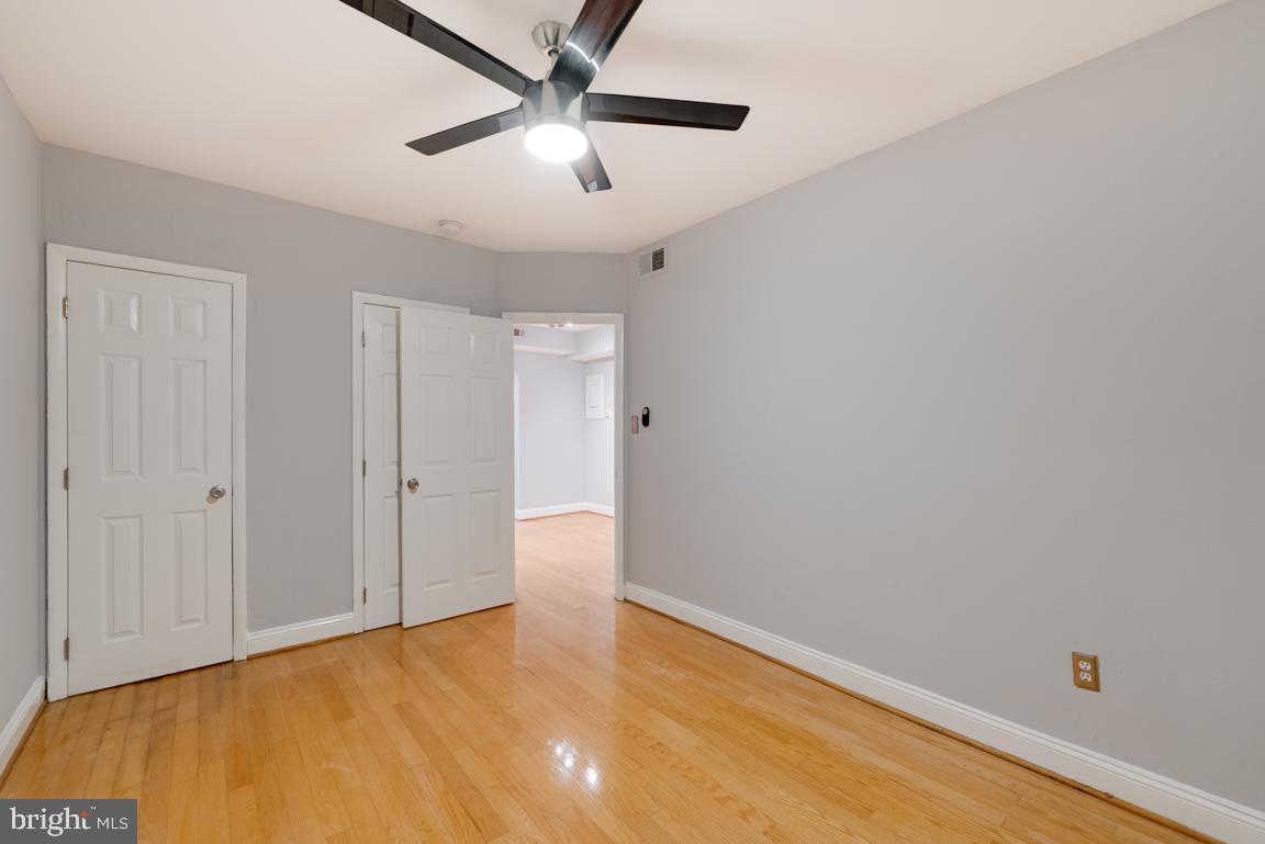 1333 Adams Street Northeast, Unit 2 Washington, DC 20018 - Photo 13 of 20 an empty room with a ceiling fan and carpet