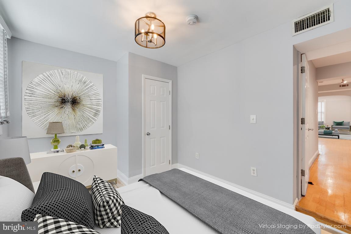 1333 Adams Street Northeast, Unit 2 Washington, DC 20018 - Photo 15 of 20 a bedroom with a bed and a chandelier