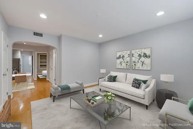 a living room with furniture and a potted plant